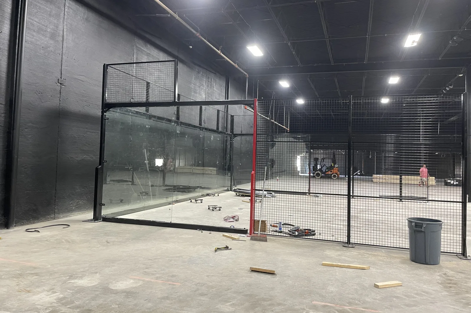 Padel court frame and glass walls being installed inside an existing building in New Orleans, Louisiana
